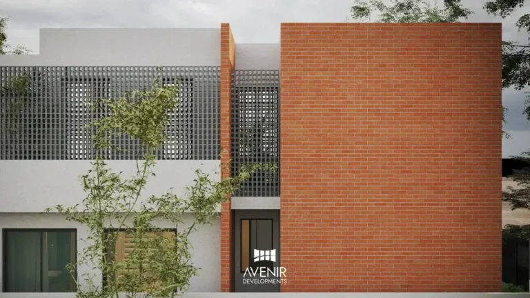 Side elevation of the DHA Phase 6 house with a brick wall and white first floor