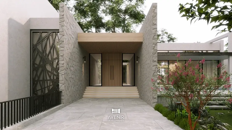 Entrance court of the Raiwind Road farmhouse, a paved approach between stone walls to a timber front door