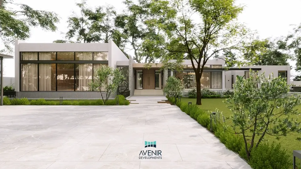Garden front of the 4 acre Raiwind Road farmhouse, a low horizontal house behind a lawn and trees